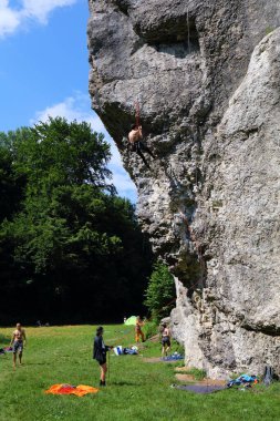 KRAKOW, POLAND - JULY 4, 2021: Climbing enthusiasts climb famous Dupa Slonia (Elephant Ass) rock in Jura rocks near Krakow, Poland.