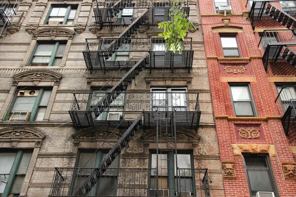 New York City, United States - old residential buildings in Chinatown district. Fire escape stairs.