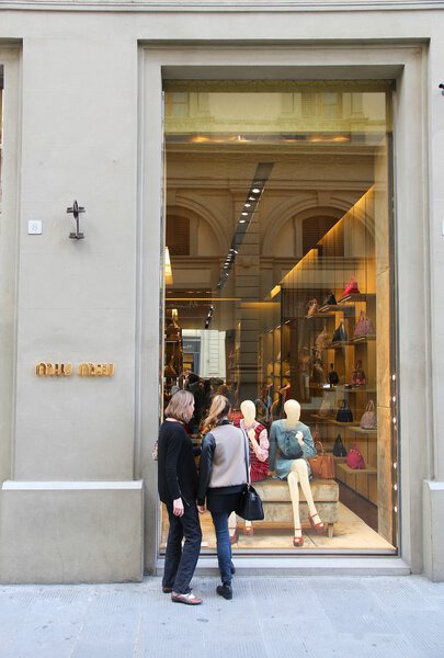 FLORENCE, ITALY - APRIL 30, 2015: People shop at Miu Miu fashion store in Florence. Miu Miu is a part of Prada, company with 3.6 billion EUR of annual revenue (2013).
