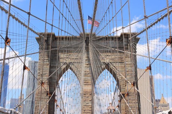 New York City, United States - famous Brooklyn Bridge with US flag.