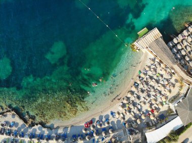 Ksamil, Arnavutluk 'un güneyindeki toplu turizm tatil beldesi. Kumsal drone görüntüsü.