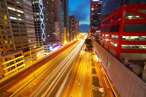 Road tunnels light trails on modern city buildings backgrounds i — Stock Photo, Image