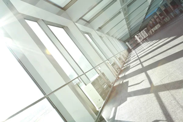 Sunny on modern glass office windows building interior corridor — Stock Photo, Image