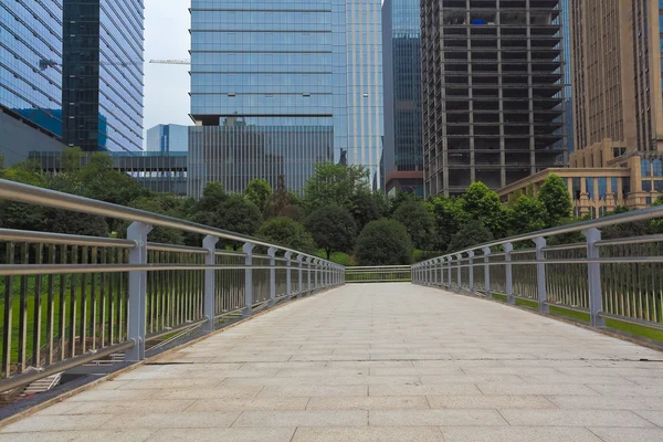 Empty road surface with modern city buildings background — Stock Photo, Image