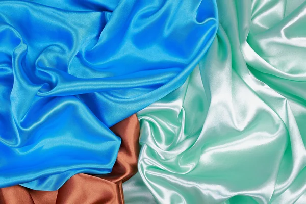 Brown and light green and blue Silk cloth of wavy abstract backg