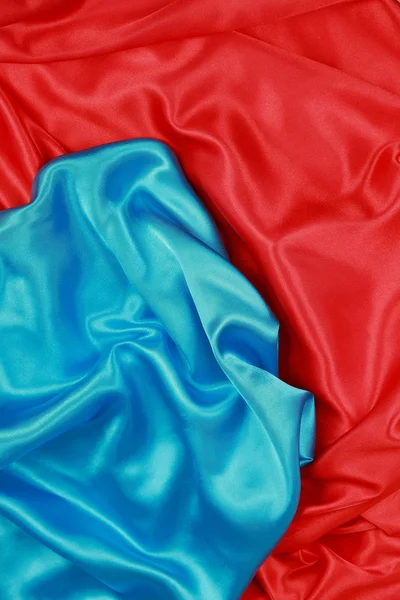 Pano de seda azul e vermelho de fundos abstratos ondulados Fotos De Bancos De Imagens Sem Royalties