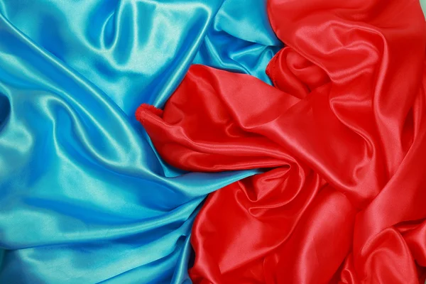 Pano de seda azul e vermelho de fundos abstratos ondulados Imagens De Bancos De Imagens