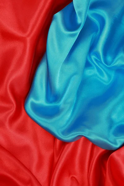 Pano de seda azul e vermelho de fundos abstratos ondulados Fotos De Bancos De Imagens