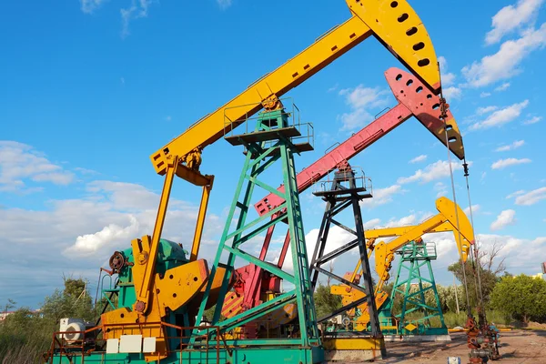 Golden yellow and pink Oil pump of crude oilwell rig — Stock Photo, Image
