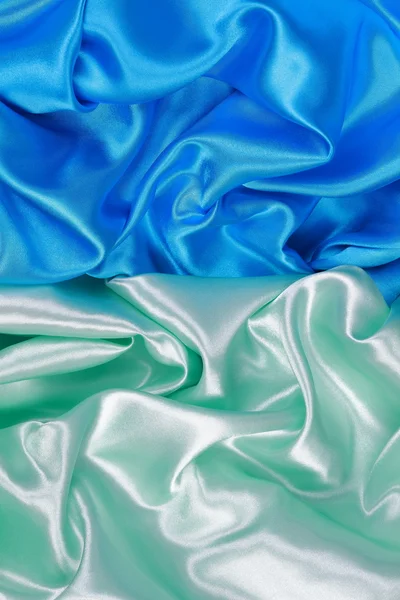 Blue and light green silk satin cloth of wavy folds texture back