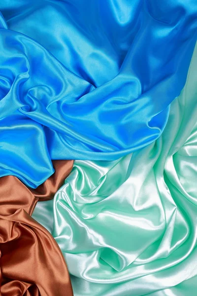 Blue and brown and light green silk satin cloth of wavy folds te