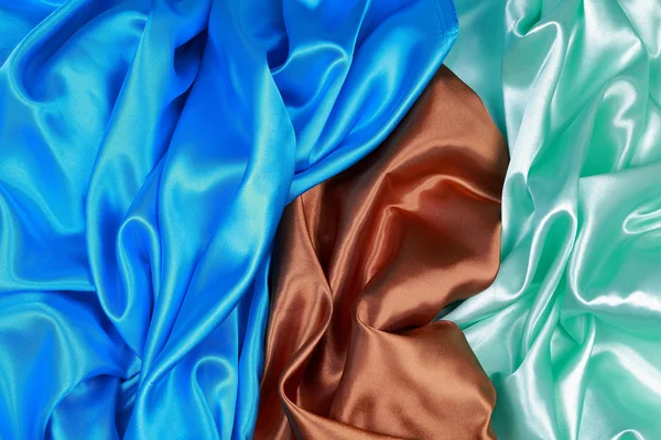 Blue and brown and light green silk satin cloth of wavy folds te