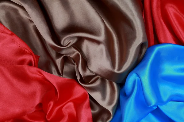 Blue and brown and red silk satin cloth of wavy folds texture ba