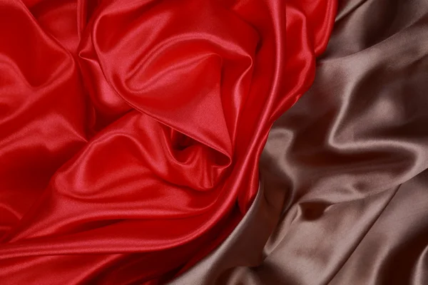 Brown and red silk satin cloth of wavy folds texture background — Stock Photo, Image