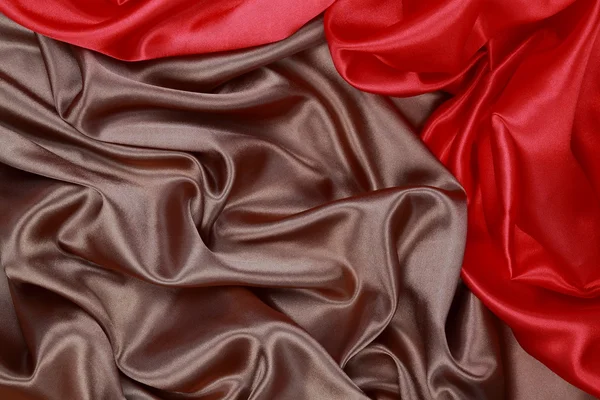 Bruin en rode zijde satijn doek van golvende plooien textuur achtergrond — Stockfoto