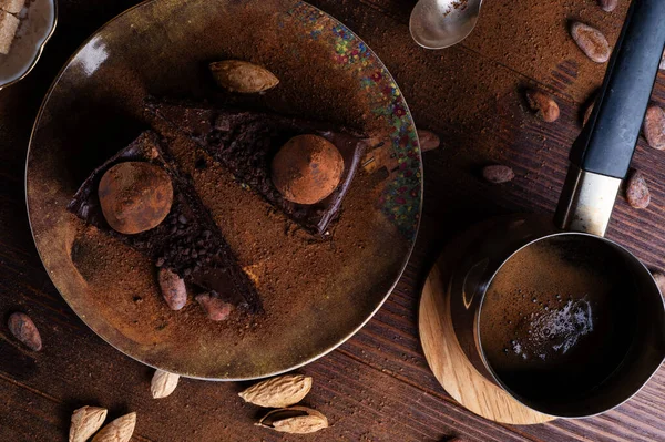 delicious chocolate truffles cakes with  coffee Cezve served at dark brown wooden table . life style concept. flat lay