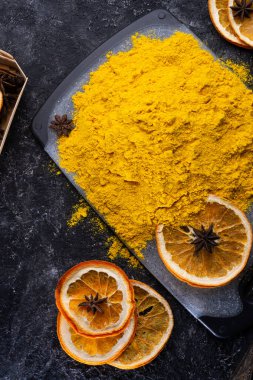 Siyah masada kuru portakallı Curcuma (zerdeçal) baharatı servis edilir. Yiyecek ve mutfak malzemeleri. Sağlıklı kavram. - Evet. düz yat