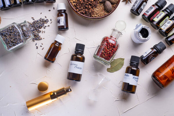  perfume ingridients around white background. Perfumer. beauty and trendy concept.  flat lay