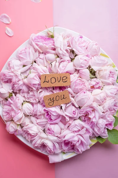 pink fresh roses  with love you written. romantic and wedding  concept background. top view