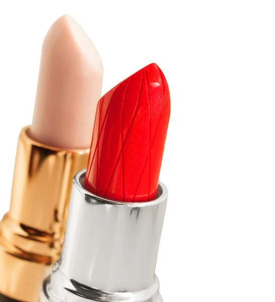 Röd och nakna lipstickes över vit bakgrund — Stockfoto