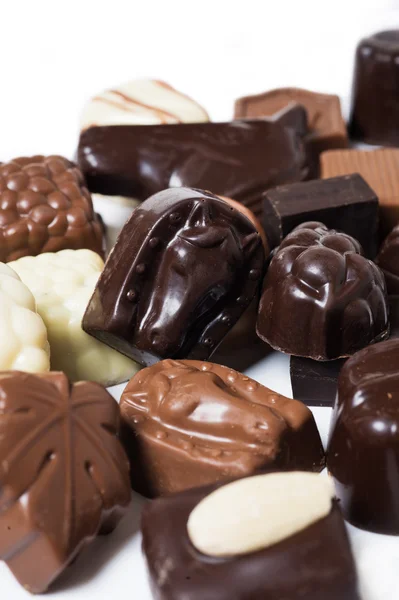 Various chocolates on white background - sweet food — Stock Photo, Image