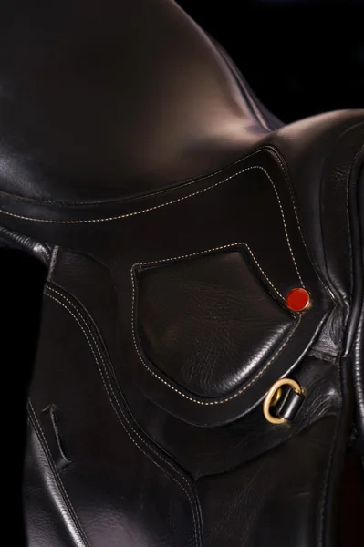 Black leather professional saddle  at black background — Stock Photo, Image