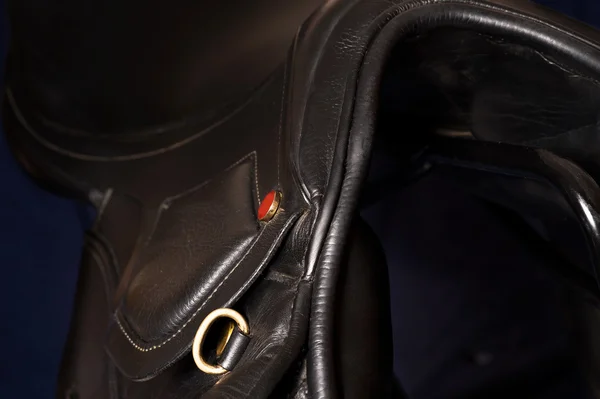 Black leather professional saddle  at black background — Stock Photo, Image