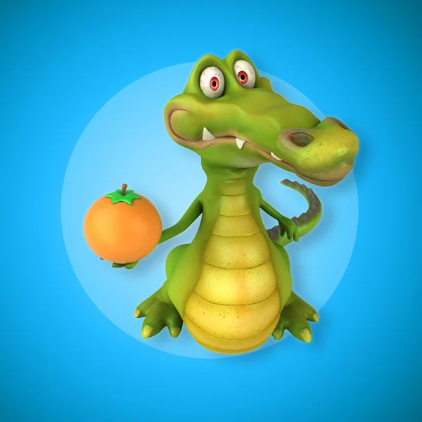 Crocodile holding orange — стоковое фото