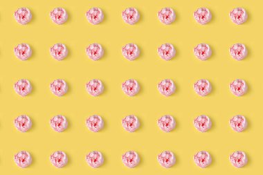 Buruşmuş pembe masa peçetesi sarı arka planda tekrarlanıyor. Asgari tasarım konsepti