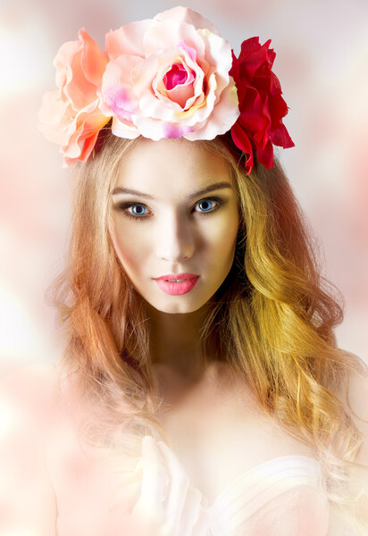 Spring, beautiful, charming woman in white bra and flowers on her head, she has got long, curly hair and natural make up.