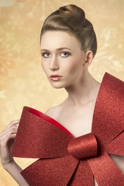 Girl with big christmas bow Stock Picture