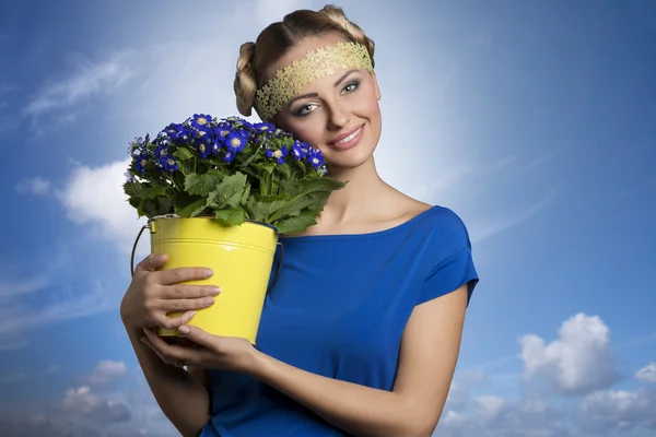 Blonde girl with flowers — Stock Photo, Image
