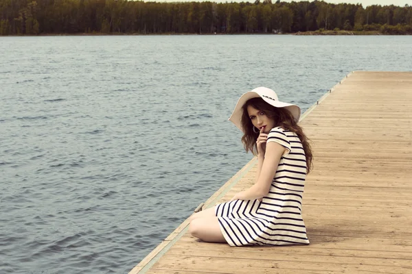 Romantic girl on jetty near lake — Stock Photo, Image