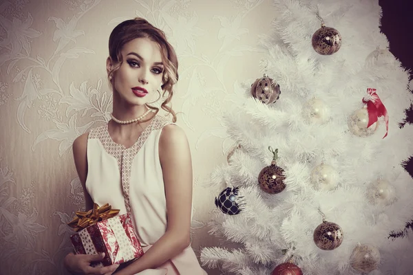 Elegant girl near christmas tree — Stock Photo, Image