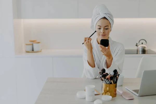 Young Refreshed Lady Applies Face Powder Cosmetic Brush Looks Herself — Stock Photo, Image