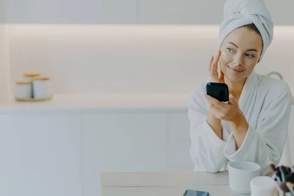 Thoughtful Beautiful Young Woman Applies Face Cream Touches Cheeks Gently — Stock Photo, Image