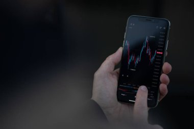 Mali grafik grafiğiyle akıllı telefon ekranına dokunan erkek el.