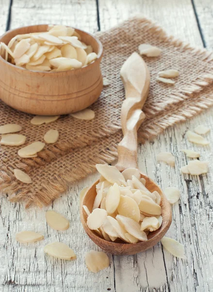 Wood spoon and bowl with almond flakes Stock Picture