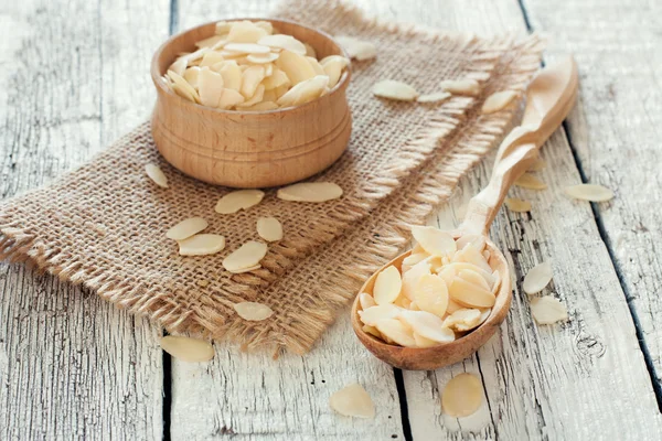 Wood spoon and bowl with almond flakes Stock Image