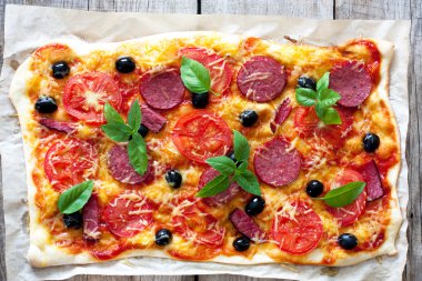 Pizza with tomatoes, cheese and salami