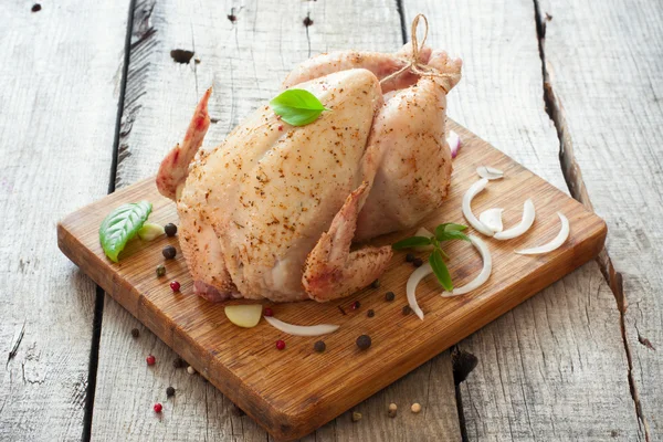 Raw whole chicken with vegetables on the wood table — Stock Photo, Image