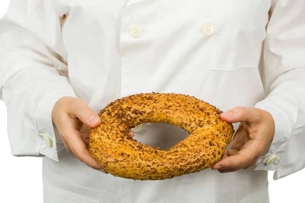 Fresh bakery in the hands of baker — Stock Photo, Image