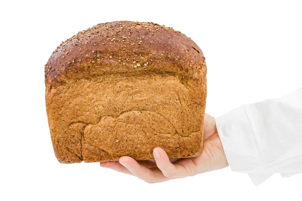 Pék, friss kenyér tartja a kezében — Stock Fotó