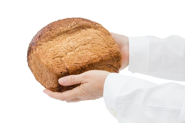 Baker holding fresh bread in the hands of, isolated on white bac — Stock Photo, Image