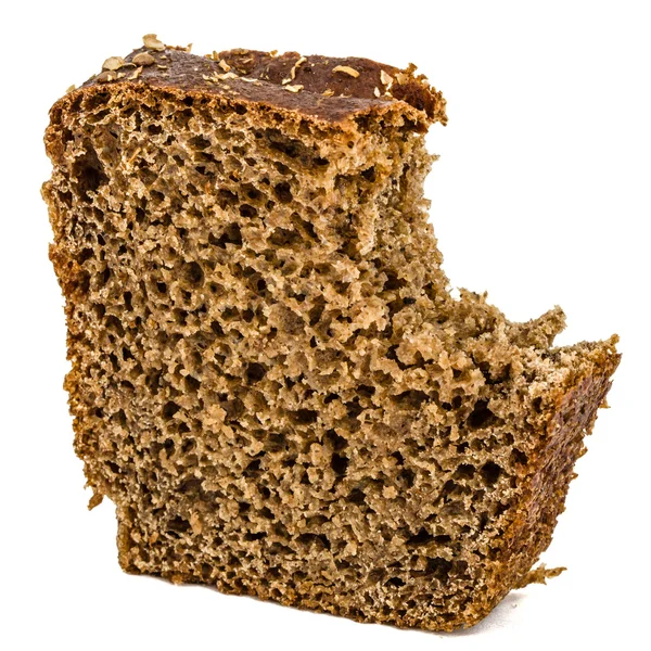 Bitten slice of bread made of dark flour, isolated on white back — Stock Photo, Image