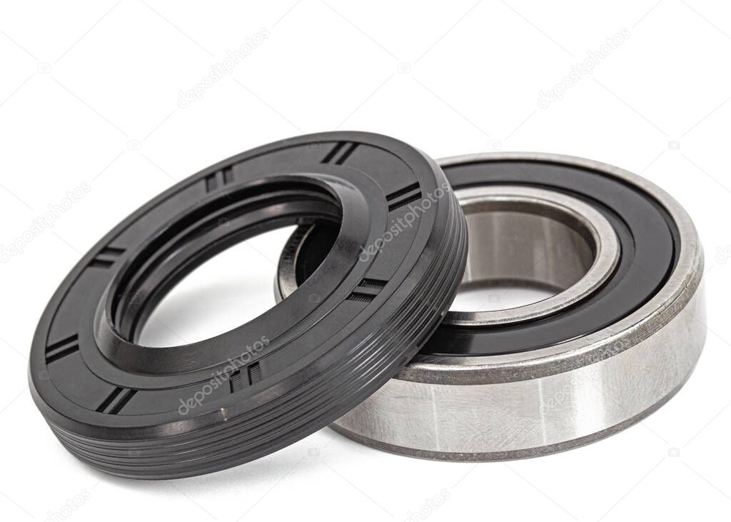 Ball bearing and oil seal for machine repair, isolated on white backgroun