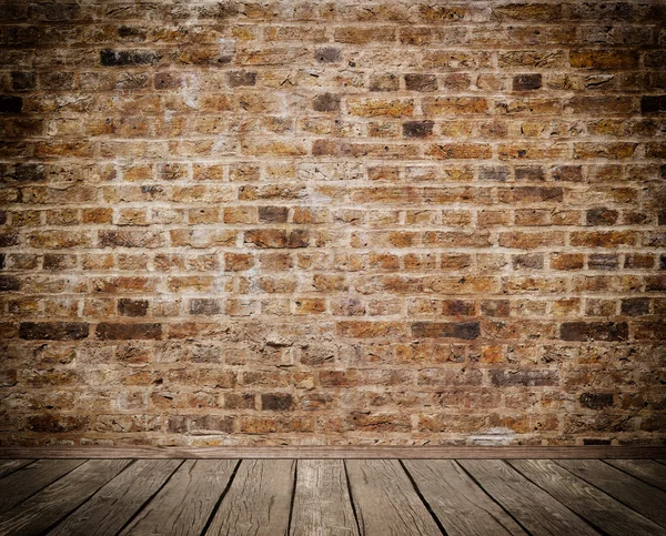 Oude bakstenen muur en houten vloer. — Stockfoto