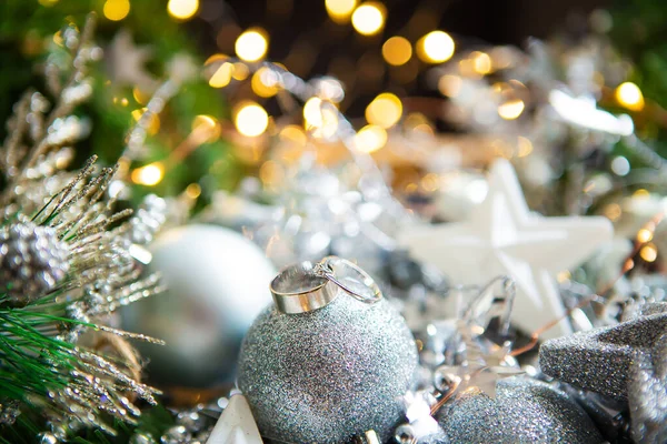 クリスマスの背景 背景に美しいボケ 結婚指輪はクリスマスボールの上にある — ストック写真