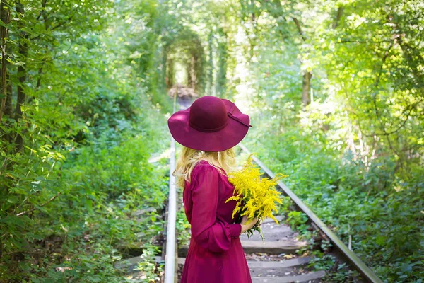 Mädchen Mit Hut Und Einem Strauß Gelber Blumen — Stockfoto