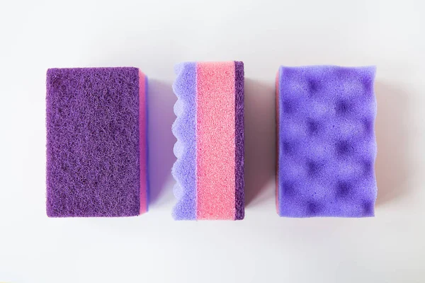 A group of multi-colored kitchen sponges. Set of colorful sponges for the kitchen. Cleaning and cleaning concept. View from above